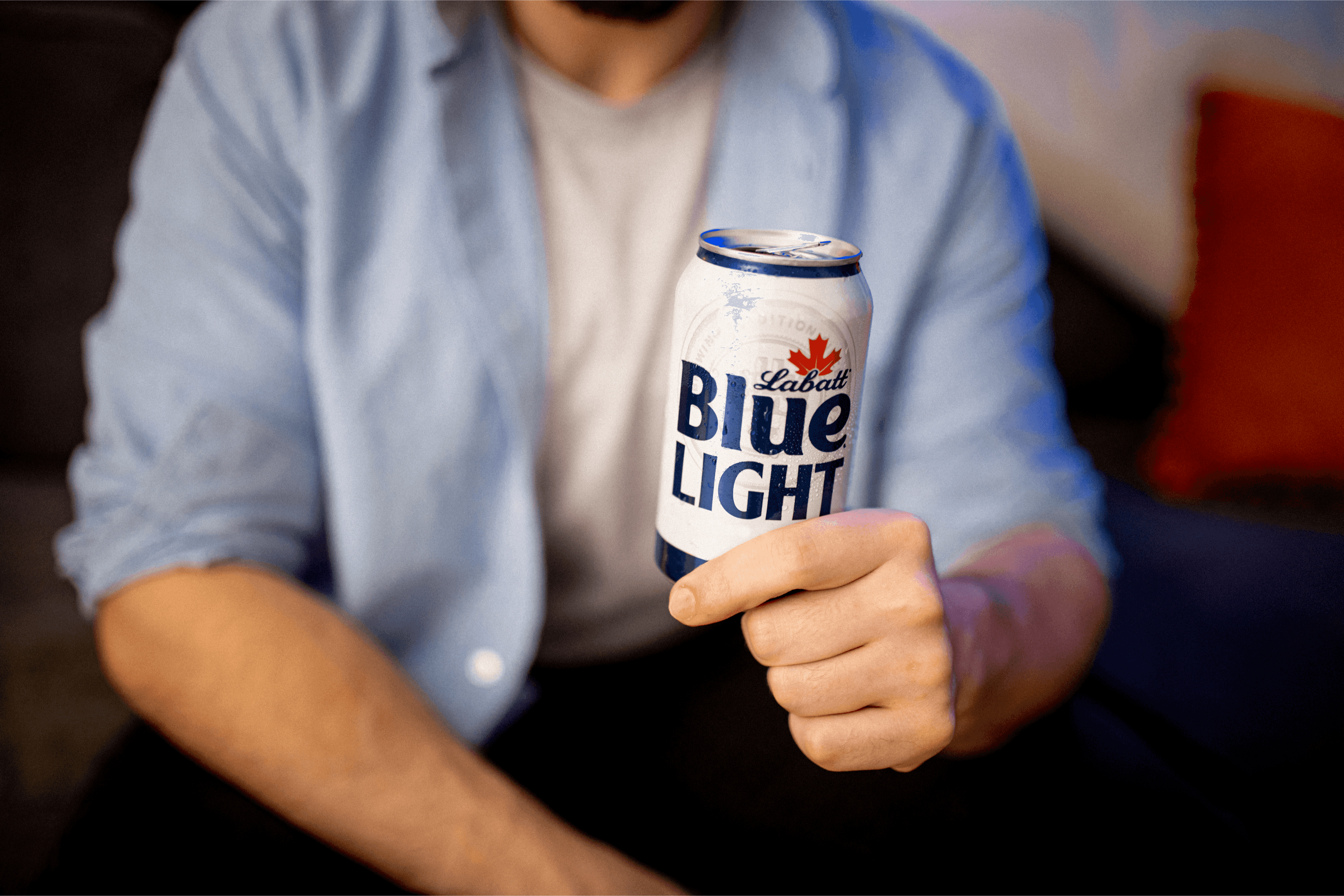 A can of Labatt Blue Light held in sharp focus