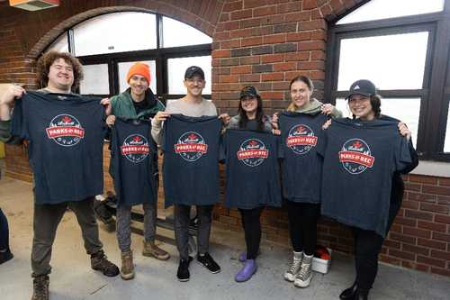 People holding Parks and Rec shirts