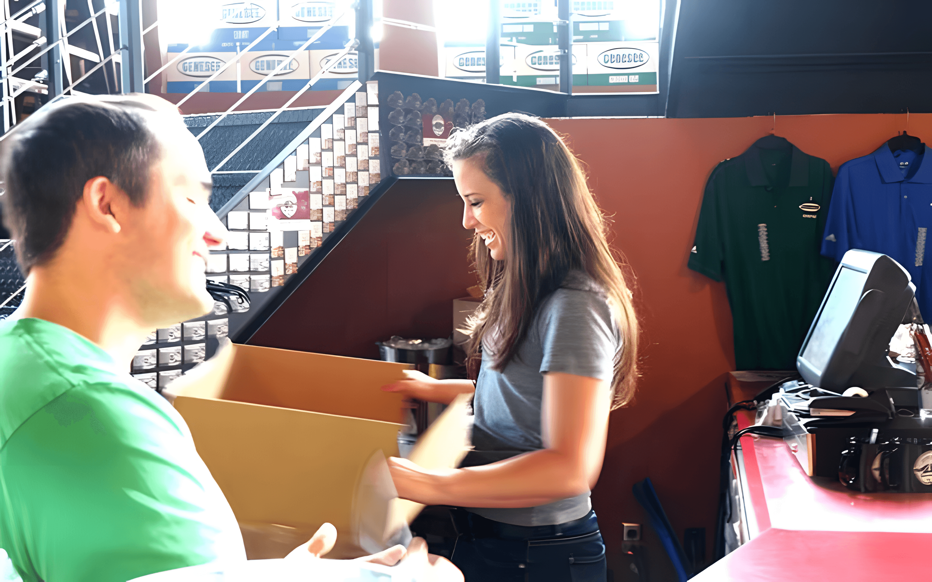 Two people packing a box