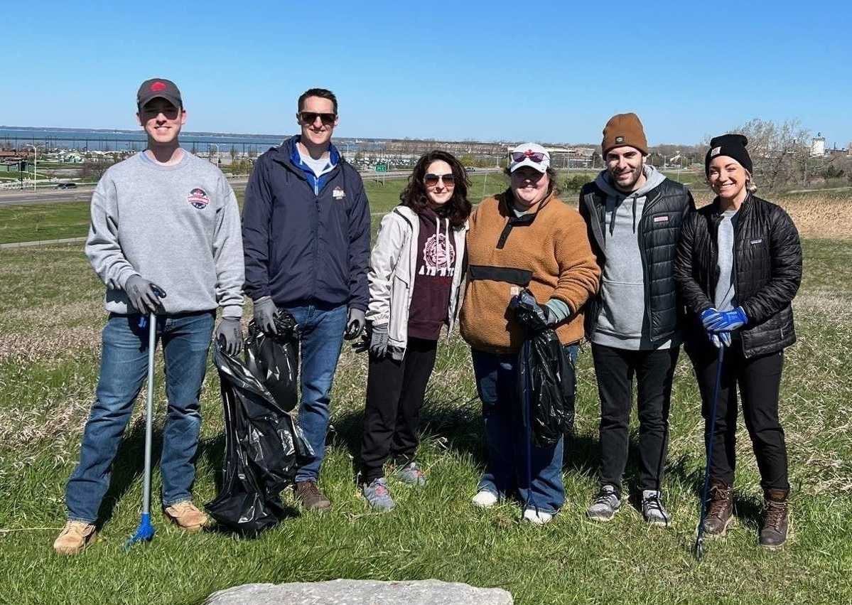 Four people take out trash